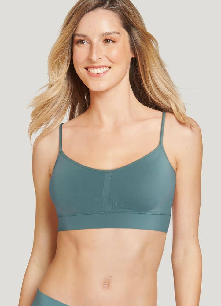 Model wearing a teal seamless wireless bralette
