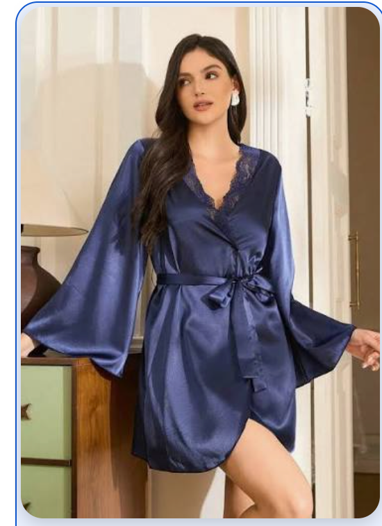 Model wearing a navy satin lingerie robe with lace trim and bell sleeves