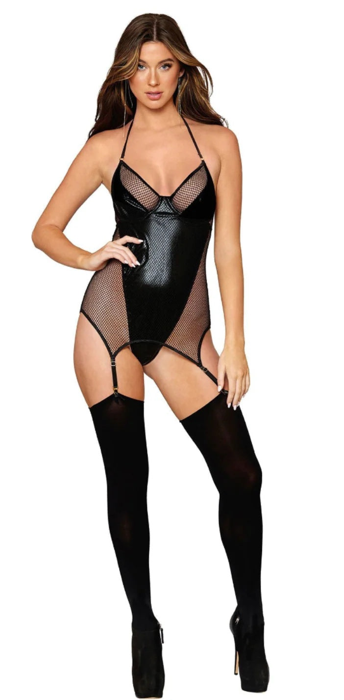 Woman wearing a black fishnet bodysuit and stockings on a white background