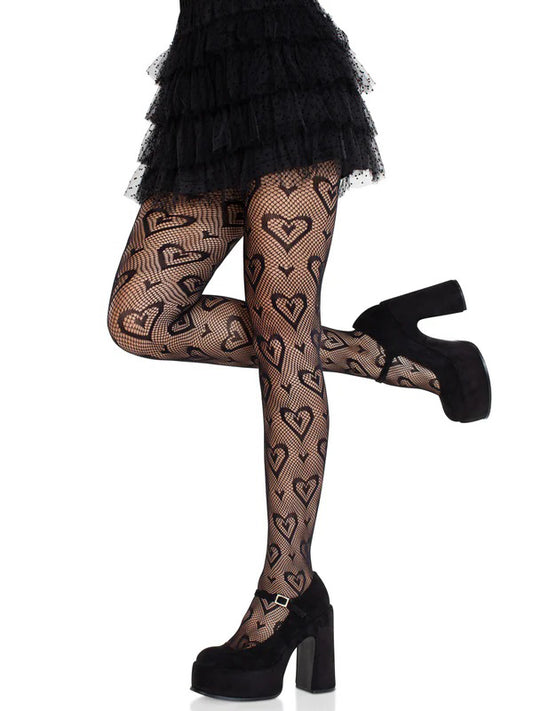 Black heart-patterned fishnet stockings worn with a black skirt and high heels on a white background